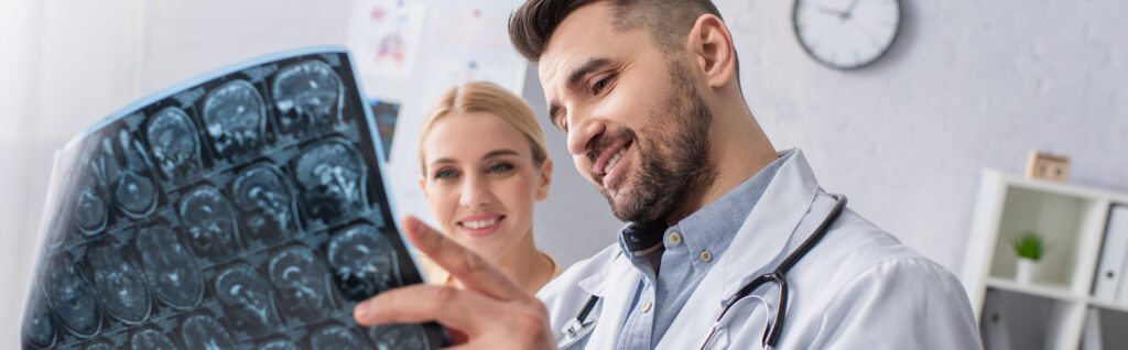 Medical staff look at an MRI image in a healthcare setting, enjoying a simpler, smarter approach to service and vendor management.