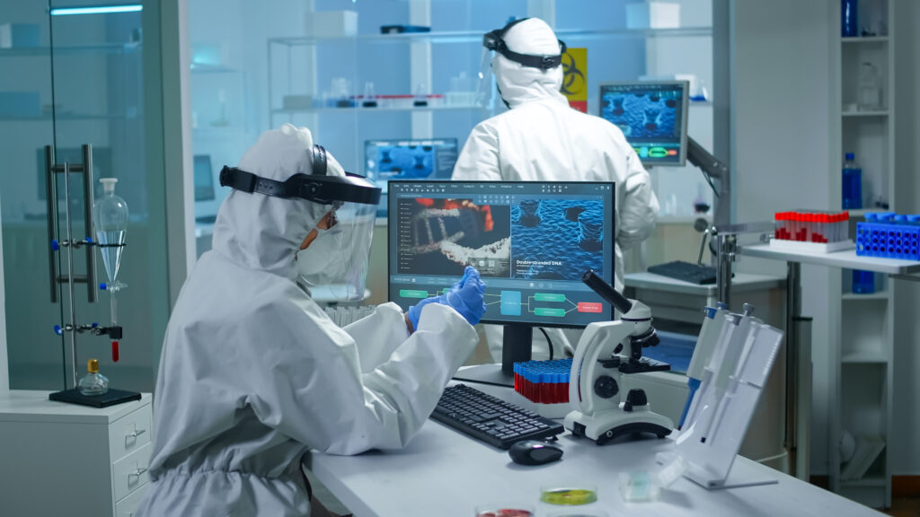 scientists in protective suits analyzing data in a laboratory